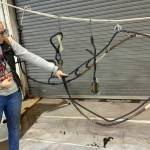 Crew member Brooke Gipson explains the importance of tarring the various components for waterproofing. (Kat Bryant | The Daily World)