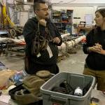 Crew member James Hsu, left, discusses treatment of one of Lady Washington's blocks with Captain Halee Grimes. (Kat Bryant | The Daily World)