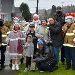 DAN HAMMOCK | THE DAILY WORLD 
Santa, Mrs. Claus and elves from the Hoquiam police and fire departments delivered gifts to this family on Chenault Avenue Monday.