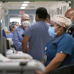 Dania Maxwell / Los Angeles Times 
Hospital doctors and nurses treat COVID-19 patients in a makeshift ICU wing Dec. 29 at Harbor UCLA Medical Center in Torrance, California.