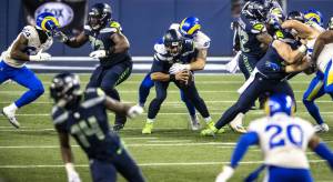 Seattle Seahawks quarterback Russell Wilson (3) is sacked by Los Angeles Rams defensive end Morgan Fox on fourth down for the last play of the game during the Wild Card round of the NFL Playoffs on Saturday, Jan. 9, 2021, at Lumen Field in Seattle. The Rams advanced, 30-20. (Photo by Bettina Hansen/Seattle Times)