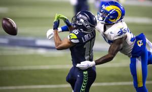 Bettina Hansen/Seattle Times 
On third down, this long pass to Seattle Seahawks wide receiver Tyler Lockett falls incomplete against Rams safety Nick Scott in the final minutes of the game during the Wild Card round of the NFL Playoffs on Saturday at Lumen Field in Seattle.