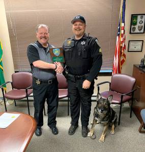 COURTESY PHOTO 
Grays Harbor County Sheriff Rick Scott, left, congratulates K9 officer Max on his handler, Sgt. Tracy Gay, for Maxs retirement after more than eight years on the force.