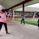 COURTESY PHOTO 
Cosmopolis second graders practicing social distancing while using hula hoops at recess. From left are Charliegh Revel and Shyla Mayr.