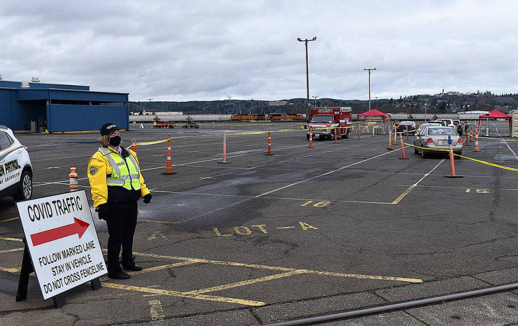 DAN HAMMOCK | THE DAILY WORLD 
After checking in at the guard shack outside the countys mass vaccination site, vehicles are directed to a second checkpoint, where people are asked if they have pre-existing conditions that would require a longer hold time after the vaccination is delivered.