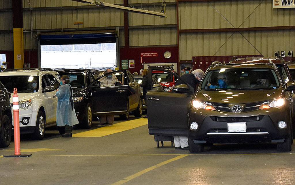 DAN HAMMOCK | THE DAILY WORLD 
A passenger in the vehicle to the right gets her COVID-19 vaccination at the countys mass vaccination site Friday.