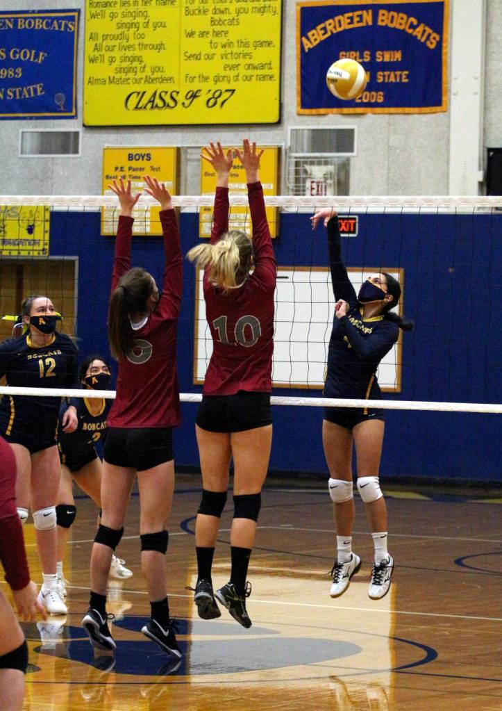 Aberdeens Alexia Padilla, right, rises for a kill attempt during the Bobcats 3-1 loss to WF West on Tuesday in Aberdeen. (Ryan Sparks | The Daily World)