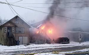 COURTESY HOQUIAM POLICE DEPARTMENT 
Flames and smoke pour from the front of a home in the 400 block of 11th Street in Hoquiam Sunday.