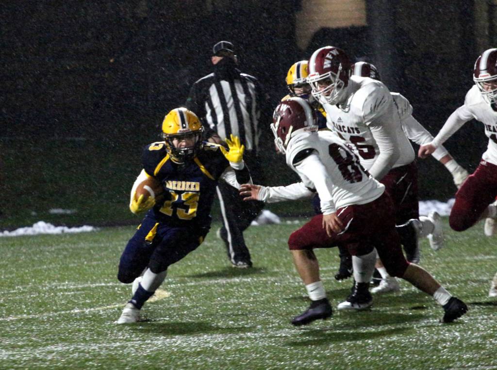 RYAN SPARKS | THE DAILY WORLD Aberdeen running back Connar Sherman, left, carries the football against WF West on Monday in Aberdeen.