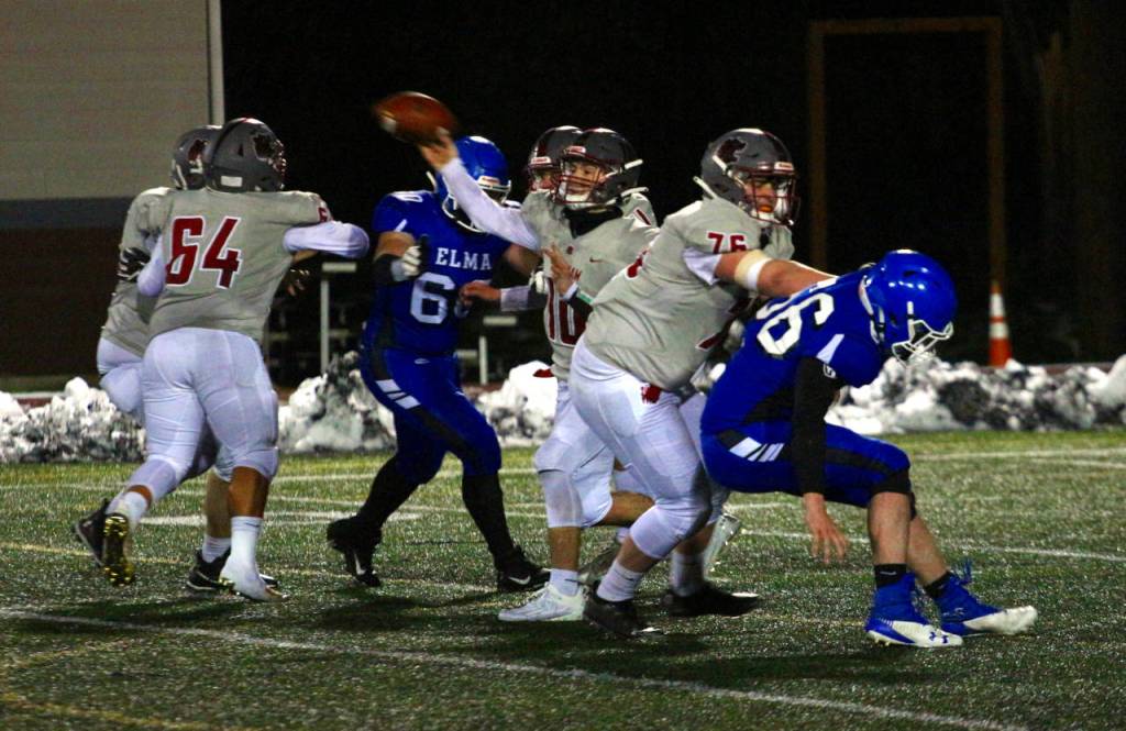 RYAN SPARKS | THE DAILY WORLD Hoquiam quarterback Dane McMillan, middle, makes a pass during the Grizzlies 27-13 loss to Elma on Monday in Montesano.
