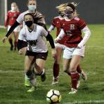 Montesanos Jaiden King, left, and Hoquiams Alyssa Perry battle for possession during Thursdays game at Olympic Stadium in Hoquiam. (Photo by Ben Winkelman)
