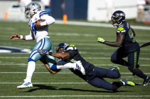 Bettina Hansen/The Seattle Times 
Seahawks outside linebacker K.J. Wright tackles Cowboys quarterback Dak Prescott on the run in the second quarter on Sept. 27 at CenturyLink Field in Seattle. Wright is the longest-tenured player on the Seahawks, the only player who predates the arrival of Russell Wilson in 2011.