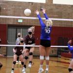 Montesano outside hitter Jessica Stanfield (10, left) smashes a kill past the block of Elmas Sarah Bridge during Montes 3-1 victory on Tuesday at Montesano High School. Stanfield tallied a game-high 16 kills in the contest. (Ryan Sparks | The Daily World)