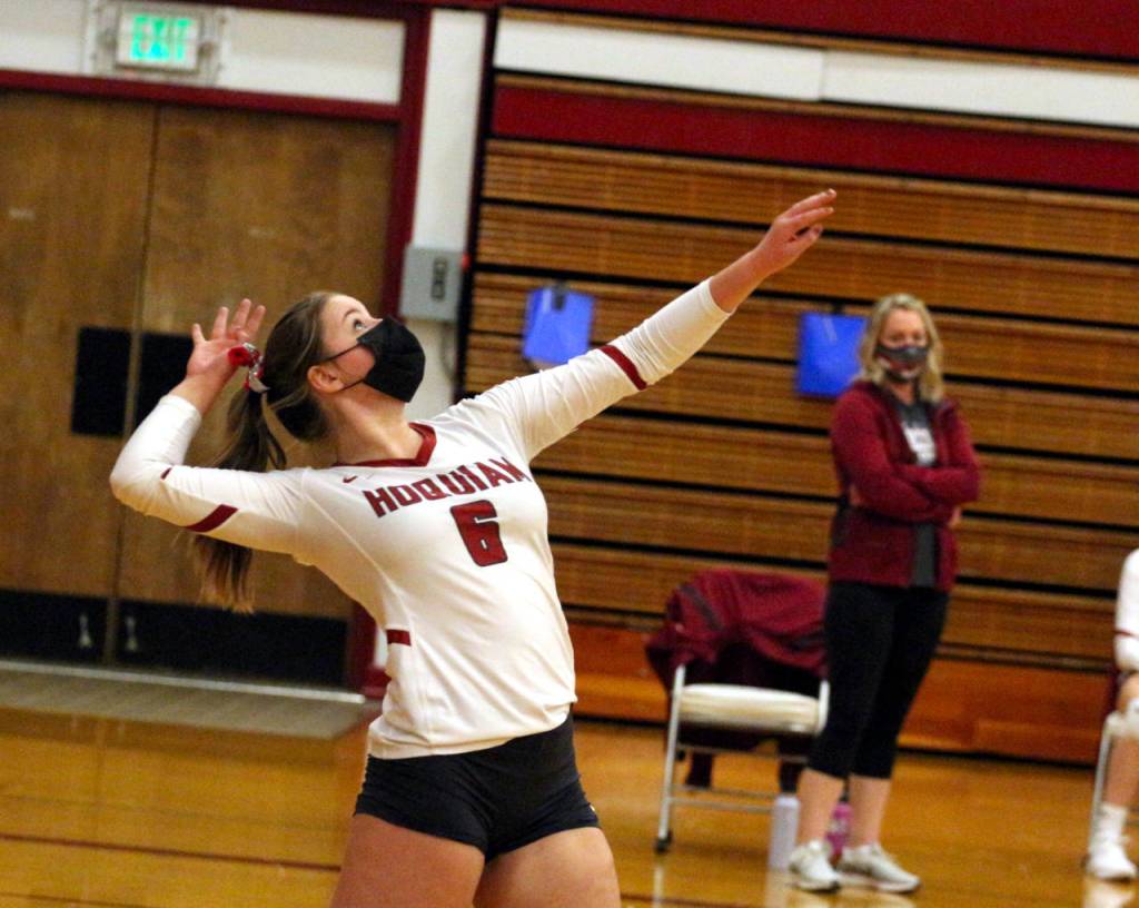 Hoquiams Kamryn Krohn serves while head coach Heather Bozich looks on in the background during a game against Elma on Tuesday in Hoquiam. Krohn had seven digs and three aces in the game. (Ryan Sparks | The Daily World)