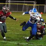 Elma running back Jarred Bailey (37) avoids Hoquiam defenders Kyrin Bretz (33) and Camden Templer during Elmas 32-8 victory on Friday in Hoquiam. (Ryan Sparks | The Daily World)
