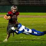 Hoquiam running back Troy McMinn, left, escapes the tackle of Elma linebacker Jarred Bailey on Friday at Olympic Stadium in Hoquiam. (Ryan Sparks | The Daily World)