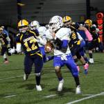 Aberdeen defender Jakob Bowers (12) chases after Rochester running back Talon Betts during the Bobcats 12-7 win on Saturday at Stewart Field in Aberdeen. (Ryan Sparks | The Daily World)
