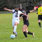 Ocosta sophomore Natalie Carloza (9) attempts to gain possession from Forks midfielder Leslie Hernandez-Beltran during the Wildcats 8-0 win on Saturday in Westport. (Photo by Ben Winkelman)