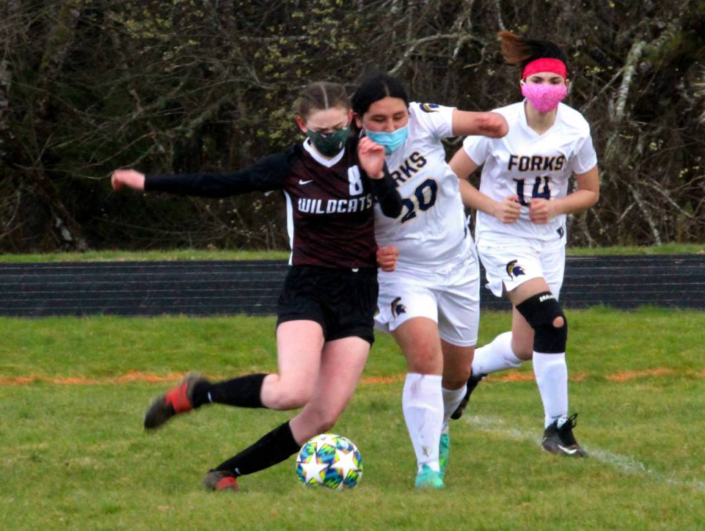 Ocosta midfielder Kylee Denny (8) battles with Forks defender Marissa Villicana during Ocostas 8-0 win on Saturday in Westport. Denny scored three goals in the contest. (Photo by Ben Winkelman)