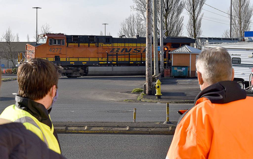 photos by DAN HAMMOCK / THE DAILY WORLD 
Aberdeen City Engineer Kris Koski, left, and Sen. Jeff Wilson watch a train cross South Newell Street in east Aberdeen Tuesday morning. Wilson was in town to get an update on the east Aberdeen rail separation project.