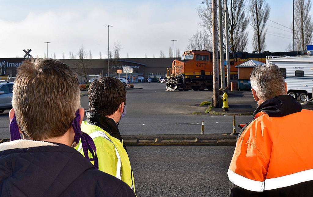 DAN HAMMOCK | THE DAILY WORLD 
A train crosses South Newell Street in east Aberdeen Tuesday morning. From left, Hoquiam City Administrator Brian Shay, Aberdeen City Engineer Kris Koski, and Sen. Jeff Wilson, talk about the east Aberdeen rail separation project.