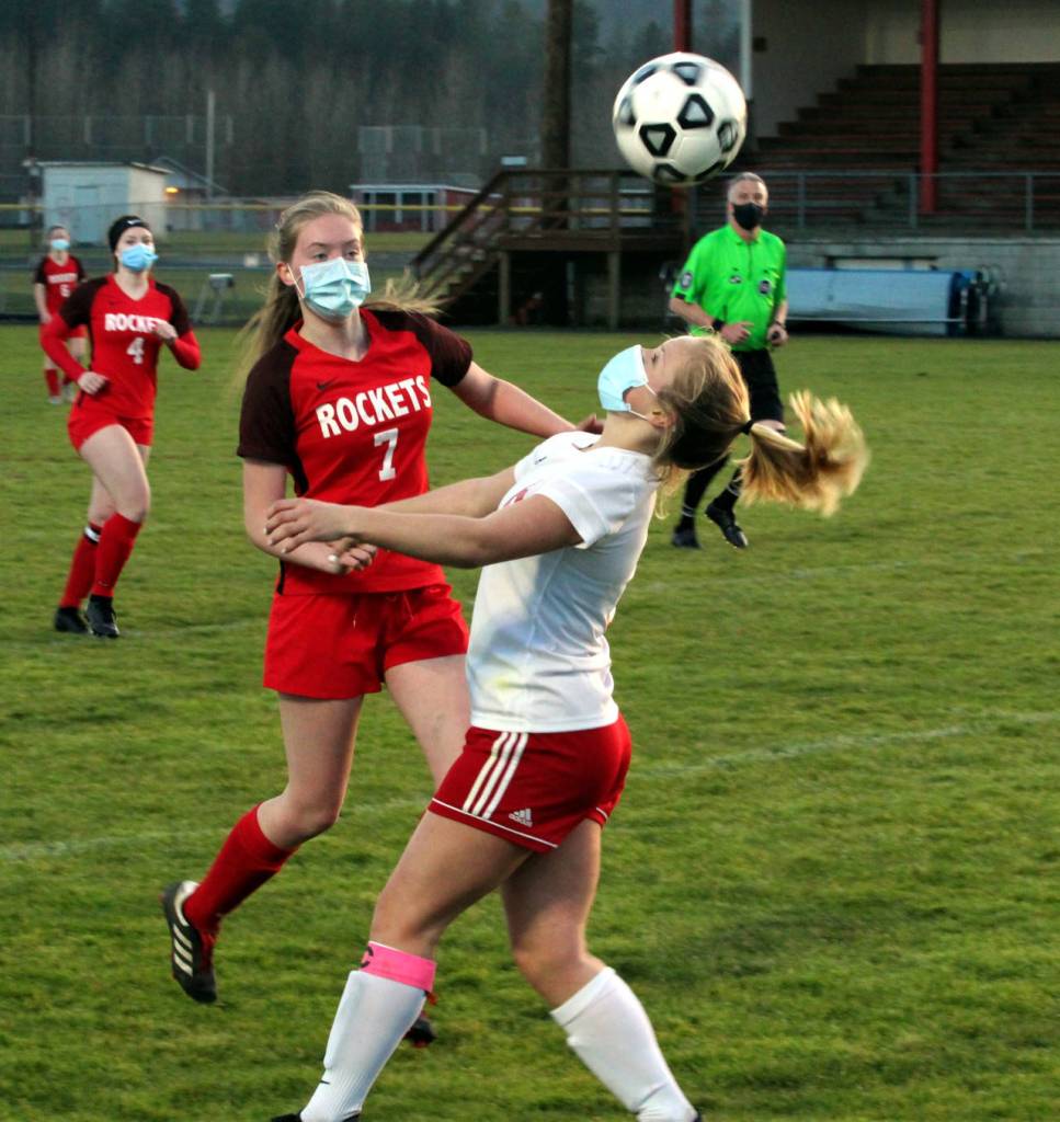 Hoquiam senior forward Sadie Carlyle uses her head while being defended by Castle Rocks Lori Ogden (7) during the Grizzlies 3-1 loss on Wednesday in Castle Rock. (Photo by Ben Winkelman)