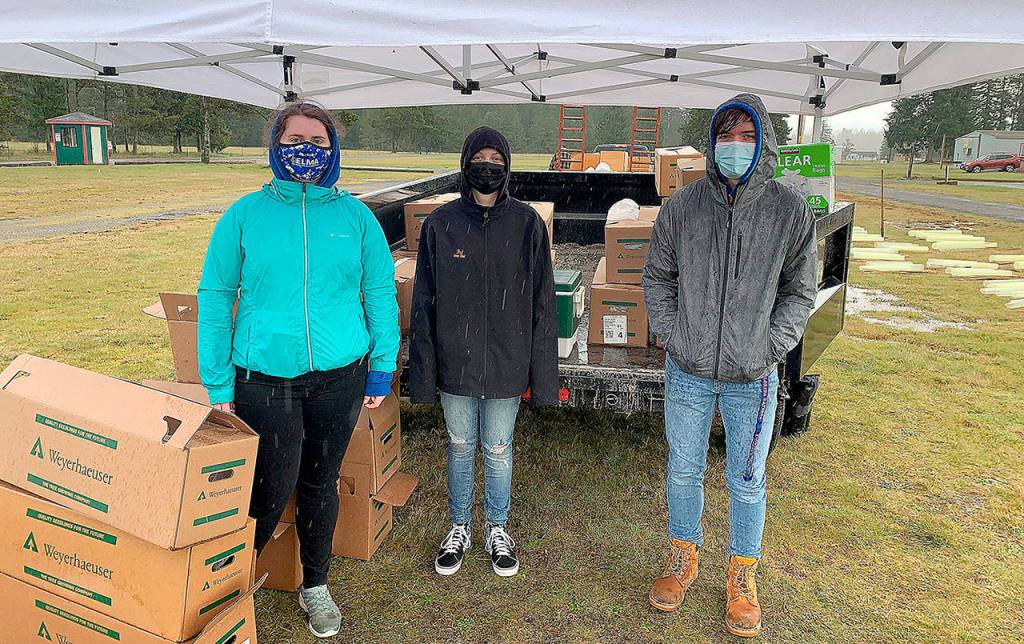TYLER RENZ | ELMA FFA ADVISOR 
Elma FFA members helped distribute 1,700 California redwood and giant sequoia seedlings at a PropagationNation giveaway at the Elma Fairgrounds March 20 and 21. Pictured from left are Alyssa Pearson, Skyler Putt and Sam Gillis.