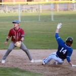 Elmas Jarred Bailey (14) steals second base as Hoquiam infielder Cody Drake awaits a throw during a double header on Tuesday in Hoquiam. (Ryan Sparks | The Daily World)