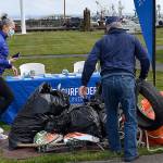 DAN HAMMOCK | THE DAILY WORLD 
Jill Williams, left, Vice Chair of the Olympia Surfriders, checks in trash collected at the south beaches Saturday at the Westport Maritime Museum.