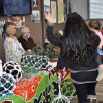 DAN HAMMOCK | THE DAILY WORLD 
Lydia Rush, left, of Poulsbo, was one of the vendors at the glass float show at the Westport Maritime Museum Saturday. Rush displayed the floats shes collected over the years, mostly during her time living in Japan. Here she talks with a family that had just returned from the beach cleanup and glass float search that ran along with the show. Vendors had floats of all shapes and sizes for sale and were available to appraise floats brought to the show, including some found by beach cleanup volunteers that day.