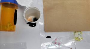 Detectives located numerous counterfeit prescription pills, believed to contain fentanyl, a loaded .380 handgun, along with cash and items consistent with the distribution and delivery of narcotics in a search of a West Aberdeen residence earlier this week. (APD Photo)
 Photo provided by Aberdeen Police Department