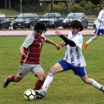 Hoquiams Kevin Catalan, left, and Elmas Jace Poston compete for possession during Elmas 9-0 victory on Wednesday in Hoquiam. (Photo by Ben Winkelman)