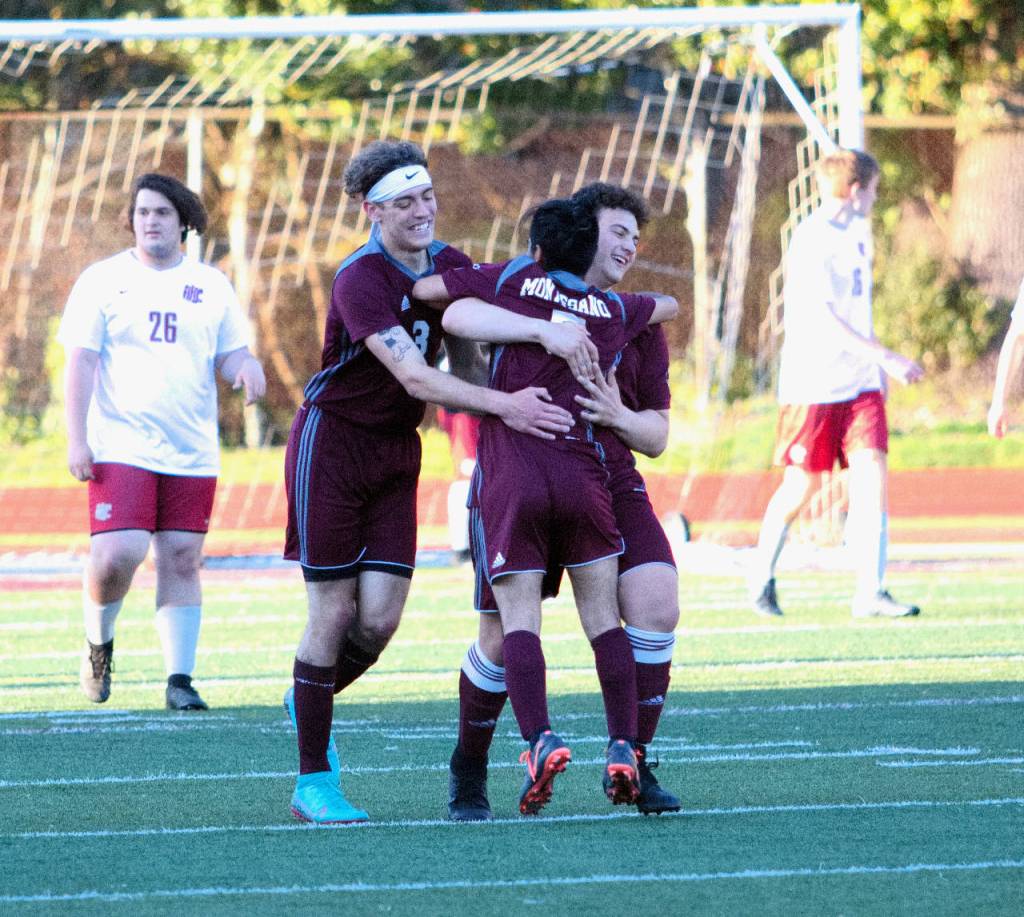 RYAN SPARKS | THE DAILY WORLD Montesanos Tucker Stecher, left, and Mateo Sanchez, right, embrace Yased Ramirez after Ramirez scored what turned out to be the game-winning goal over Hoquiam on Thursday in Montesano.