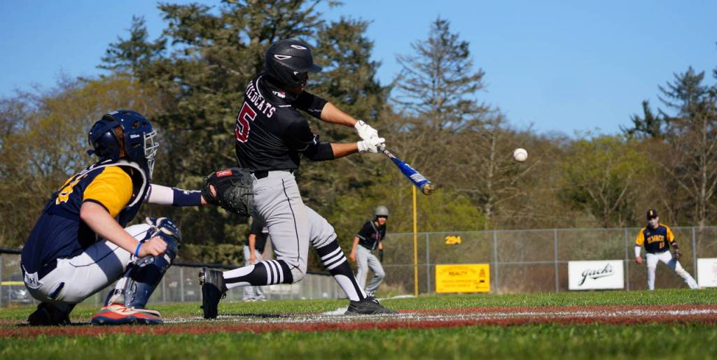 PHOTO BY ROB HILSON Ocostas Harley Figueroa belts and RBI single to center field during Ocostas 13-9 loss to Ilwaco on Friday in Long Beach.
