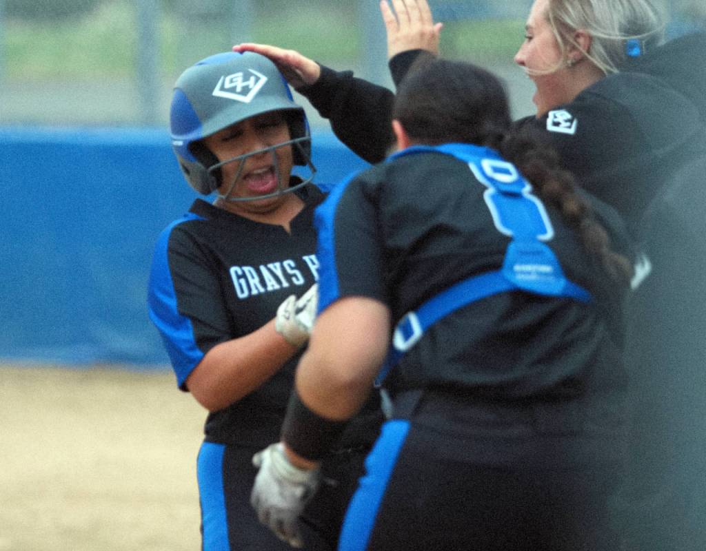 RYAN SPARKS | THE DAILY WORLD Grays Harbor College infielder Shaylee Bisbee, left, is congratulated by her teammates after belting a home run during the second game of a doubleheader against Centralia College on Wednesday in Aberdeen.
