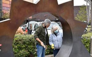 DAN HAMMOCK | THE DAILY WORLD 
Christine Peck has been cleaning the Illumination statue at the corner of East Wishkah and I Street in Aberdeen twice a year since 2014. Friday, she passed the torch to Downtown Aberdeen Association Director Wil Russoul. The installation was placed in 2005, the work of Gerard Tsutakawa, funded by the Kathryn N. Sherk bequest.