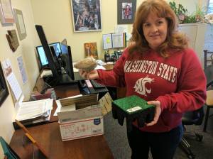 DAVE HAVILAND THE DAILY WORLD Principal Cherrie Patterson holds a sample of the new turf that was installed on the Cosmopolis school playground in 2018.