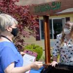 DAVE HAVILAND THE DAILY WORLD From left to right, Eldergrow Program Administrator Catherine Booth explains some of the procedures to Director of Therapy Bobbie Cheville.