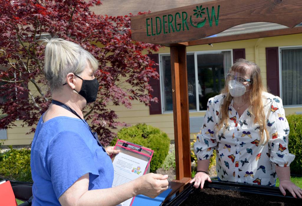 DAVE HAVILAND THE DAILY WORLD From left to right, Eldergrow Program Administrator Catherine Booth explains some of the procedures to Director of Therapy Bobbie Cheville.