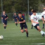 RYAN SPARKS | THE DAILY WORLD Aberdeens Miguel Martinez gets past Black Hills defender Shane Braz on his way to scoring a goal in the second half of the Bobcats 4-0 victory in the first round of the 2A District 4 Tournament on Saturday at Stewart Field in Aberdeen.