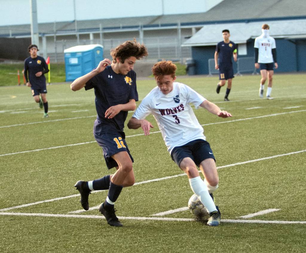 RYAN SPARKS | THE DAILY WORLD Aberdeens Carlos Mendoza (12) gets past Black Hills Zak Gilal during the first half of the Bobcats 4-0 win in a 2A District 4 Tournament game on Saturday at Stewart Field in Aberdeen.
