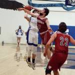 RYAN SPARKS | THE DAILY WORLD Elmas Sawyer Witt (13) avoids the block of Hoquiams Dane McMillan during the Grizzlies 66-63 season-opening overtime victory on Friday in Elma.