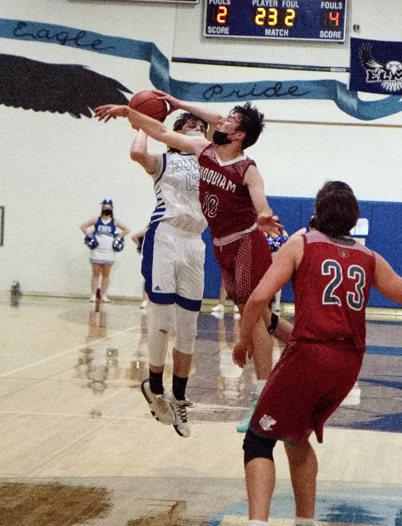 RYAN SPARKS | THE DAILY WORLD Elmas Sawyer Witt (13) avoids the block of Hoquiams Dane McMillan during the Grizzlies 66-63 season-opening overtime victory on Friday in Elma.
