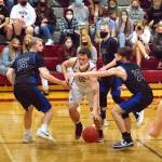 RYAN SPARKS | THE DAILY WORLD Montesano senior Trace Ridgway (10) is hounded by Elmas Cobey Moore (10) and Brady Johnston (15) during the Bulldogs 53-37 victory on Friday in Montesano.