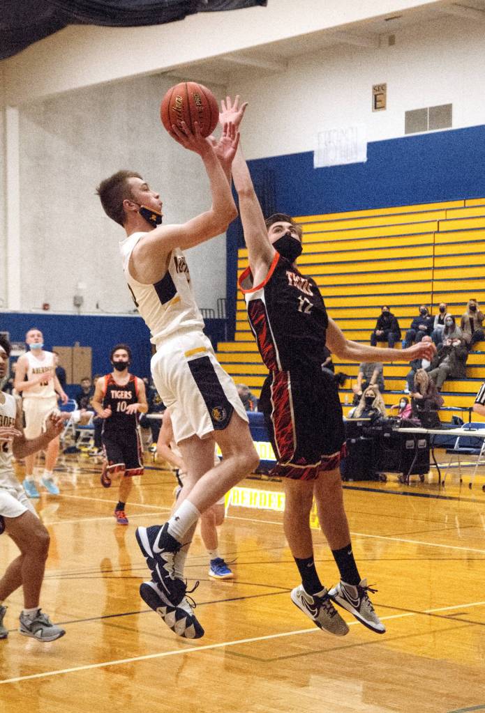 RYAN SPARKS | THE DAILY WORLD Aberdeens Andrew Troeh, left, puts up a jump shot against Centralias Landon Kaut during the Bobcats 56-48 loss on Monday in Aberdeen.