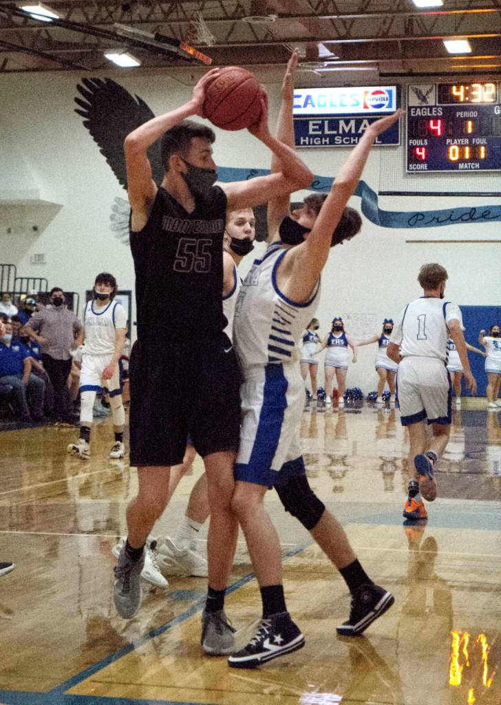 RYAN SPARKS | THE DAILY WORLD Montesanos Mason Dineen (55) secures a rebound against Elmas Cobey Moore during the Bulldogs 62-43 loss to Elma on Tuesday in Elma. Dineen led Monte with 13 points.
