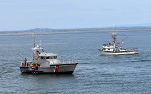 DAN HAMMOCK | THE DAILY WORLD
Coast Guard Station Grays Harbor personnel place the memorial reef at Sundays Blessing of the Fleet in Westport. In the background is commercial troller Brittany May, one of four commercial vessels to join in the ceremony.