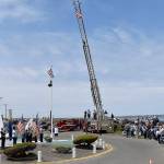 DAN HAMMOCK | THE DAILY WORLD
The presentation of the colors at Sundays Blessing of the Fleet in Westport. Presenting the colors were the U.S. Coast Guard and members of local veterans associations. At center, at the base of the flag pole, Greg Barnes prepares to ring the memorial bell as names of those who lost their lives at sea are read aloud. The ceremony began with the raising of the flag on the South Beach Regional Fire Authority ladder truck in the background.