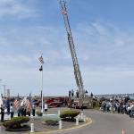 DAN HAMMOCK | THE DAILY WORLD
The presentation of the colors at Sundays Blessing of the Fleet in Westport. Presenting the colors were the U.S. Coast Guard and members of local veterans associations. At center, at the base of the flag pole, Greg Barnes prepares to ring the memorial bell as names of those who lost their lives at sea are read aloud. The ceremony began with the raising of the flag on the South Beach Regional Fire Authority ladder truck in the background.