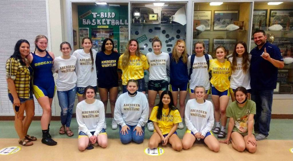 NIC CORTEZ | MATFOCUS.COM The Aberdeen High School girls wrestling team coached by Craig Yakovich, far right, won its sixth straight district championship in a dominant performance at the 2A District 4 Championship Tournament on Tuesday in Tumwater.
